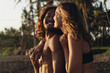 © mnelen.com - A loving couple against a background of palm trees and sand stand in a hug and smile at each other man and woman. High quality photo