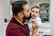 © Inti St. Clair - Man with beard kissing happy baby on the cheek