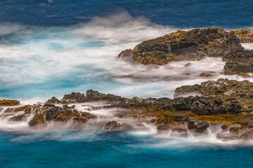 Sticker - Long exposure on surf along rocky beach, Maui, Hawaii.