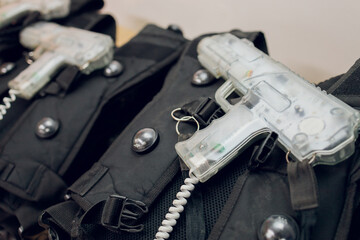 Weapons close-up on a military man standing inside the building and waiting for command.