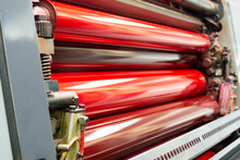 Color And Glossy Rollers Of Komori Offset Printing Machine. Offset Ink Colour. Magenta, Red.