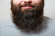 © BetterPhoto - Portrait. The man with the thick beard smiles.
