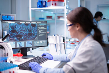 Wall Mural - woman biotechnology scientist working at computer researching in development laboratory. chemistry r