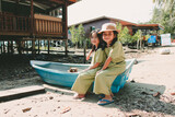 Fototapeta Natura - Portrait of Two little girls sitting in boat