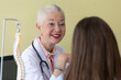© Bangkok Click Studio - Senior older female doctor taking, explaining and history taking with a patient with a smiley face and intimate manner