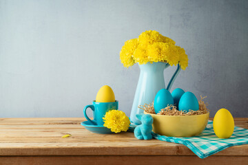 Wall Mural - Easter holiday concept with Easter eggs, flowers and bunny decoration on wooden table