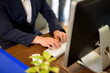 © SizeSquare's - Business man's hand focus presses the keyboard working in front of.
