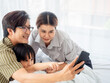 © anusak - happy family in bed room concept. Enjoying being together. Lying in bed and making selfie.
