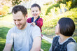 © Andy Dean - Happy Mixed Race Family Having Fun Outside on the Grass