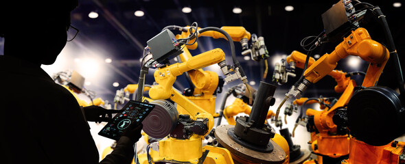Canvas Print - Factory Female Industrial Engineer working with automation robot arms machine in intelligent factory industrial on real time monitoring system software.Digital future manufacture.