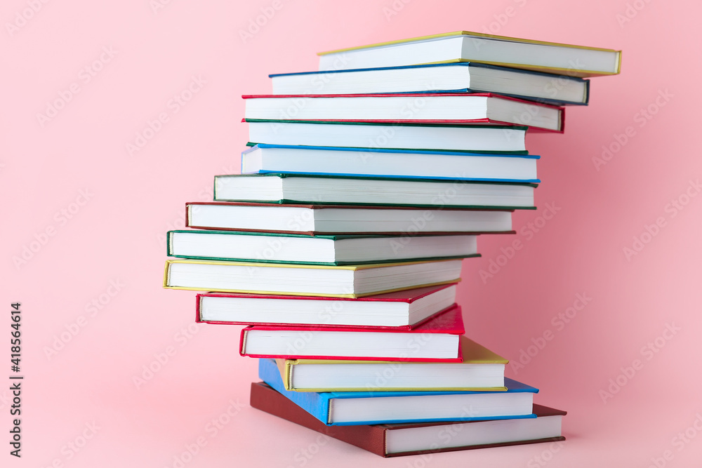 Stack of books on color background