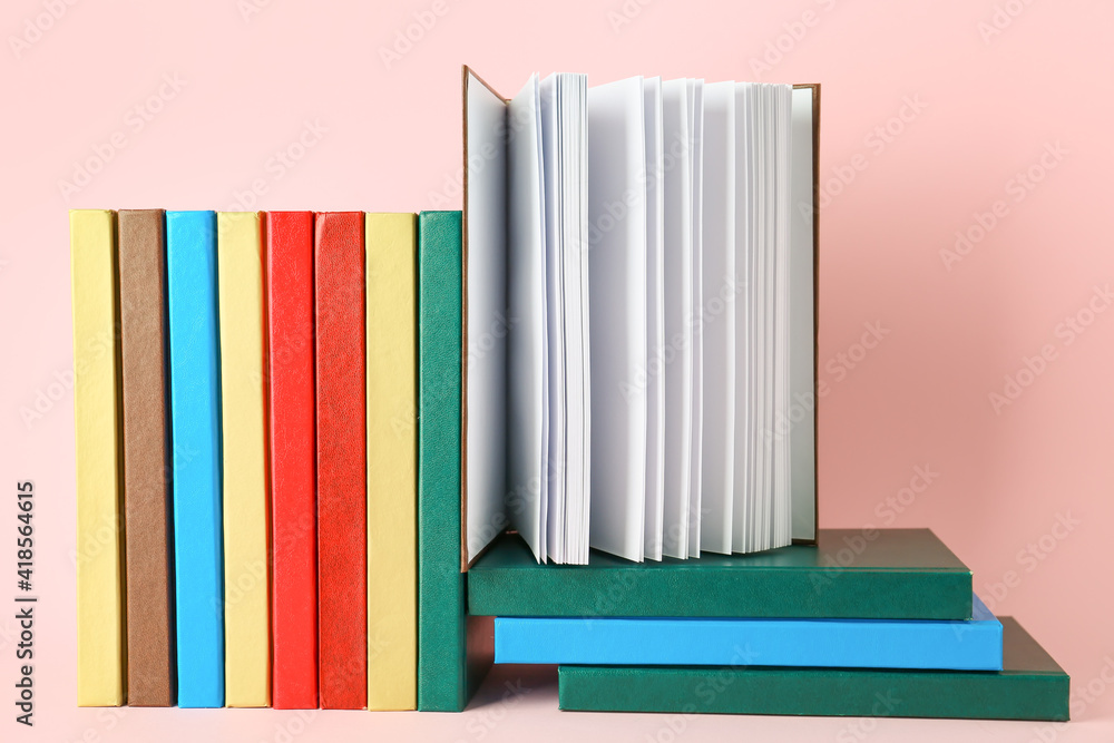 Stack of books on color background