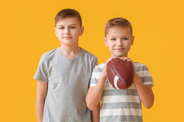 Sticker - Cute little boys with rugby ball on color background