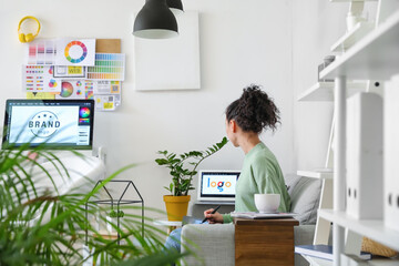 Young female designer working in office