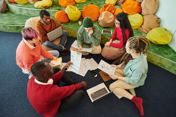 Wall Mural - Group of intercultural financial managers brainstorming and discussing papers