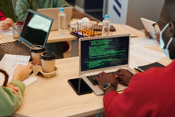 Poster - Hands of contemporary software developer using laptop while decoding information