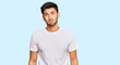 © Krakenimages.com - Young handsome man wearing casual white tshirt puffing cheeks with funny face. mouth inflated with air, crazy expression.
