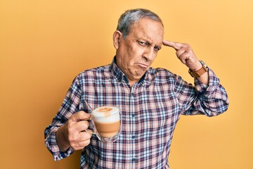 Poster - Handsome senior man with grey hair drinking a cup coffee shooting and killing oneself pointing hand and fingers to head like gun, suicide gesture.