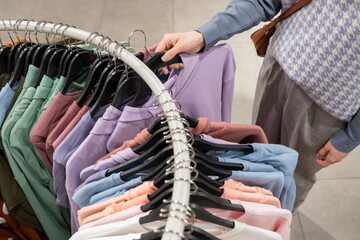 Wall Mural - Woman buying shirt in the store