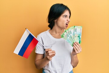 Poster - Young caucasian woman holding pills angry and mad screaming frustrated and furious, shouting with anger. rage and aggressive concept.