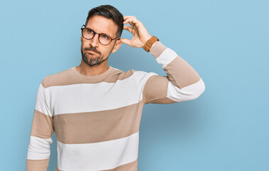 Poster - Handsome man with beard wearing casual clothes and glasses confuse and wondering about question. uncertain with doubt, thinking with hand on head. pensive concept.