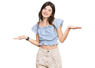 Young beautiful caucasian girl wearing casual clothes smiling showing both hands open palms, presenting and advertising comparison and balance