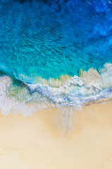 Travel and vacation image. Coast as a background from top view. Blue water background from air. Summer seascape from drone. Strong waves.