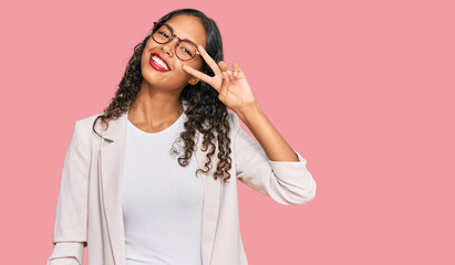 Poster - Young african american girl wearing business clothes doing peace symbol with fingers over face, smiling cheerful showing victory