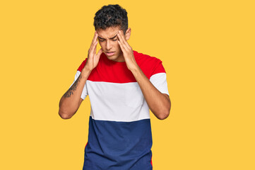 Canvas Print - Young handsome african american man wearing casual clothes with hand on head for pain in head because stress. suffering migraine.