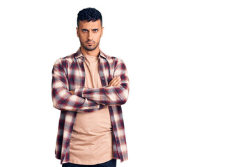 Wall Mural - Young hispanic man wearing casual clothes skeptic and nervous, disapproving expression on face with crossed arms. negative person.