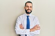 © Krakenimages.com - Young man with beard wearing business tie happy face smiling with crossed arms looking at the camera. positive person.