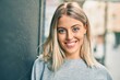 © Krakenimages.com - Young blonde girl smiling happy standing at the city.