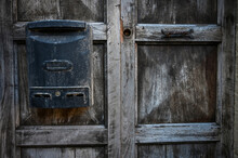 Old Wooden Door. Old Vintage Mailbox On A Old Aged Wooden Entrance Door. Grunge Wooden Texture. 