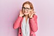 © Krakenimages.com - Young caucasian woman wearing business style and glasses trying to hear both hands on ear gesture, curious for gossip. hearing problem, deaf
