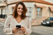© Krakenimages.com - Young irish plus size girl smiling happy using smartphone at the city.