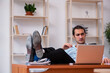 © Elnur - Young male employee sitting in the office