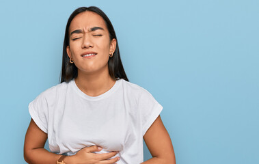 Canvas Print - Young asian woman wearing casual white t shirt with hand on stomach because nausea, painful disease feeling unwell. ache concept.