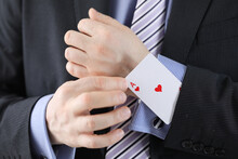 Businessman Pulling Ace Out Of His Jacket Pocket Closeup. Confidence In Victory Concept
