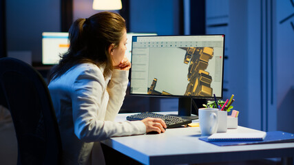 Wall Mural - Tired woman architect working on modern cad program overtime sitting at desk in start-up office. Industrial female engineer studying prototype idea on pc showing cad software on device display