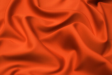 Wall Mural - Close-up texture of natural red or orange fabric or cloth in same color. Fabric texture of natural cotton, silk or wool, or linen textile material. Red and orange canvas background.