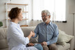 © fizkes - Smiling female doctor shake hand greet get acquainted with optimistic mature male patient at home visit. Happy woman nurse handshake man close health insurance deal. Elderly healthcare concept.
