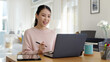 © ChayTee - Young attractive business asian woman talking about sale report in video call conference on notebook computer online meeting in working from home, Working remotely and Social isolation concept.