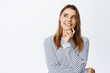 © Cookie Studio - Portrait of thoughtful blond woman having an idea, looking pensive at upper left corner, imaging something good, standing against white background