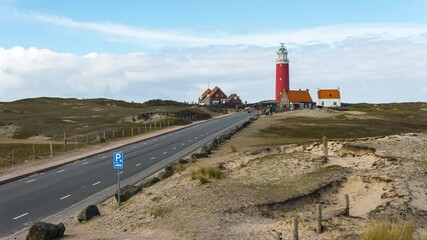 Wall Mural - 4k time lapse of the Texel lighthouse with white clouds passing by and blue sky background