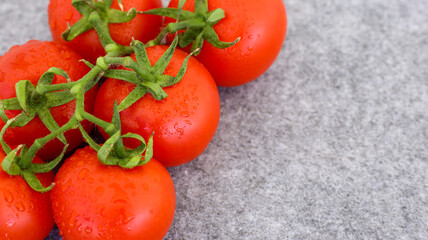 bright homemade tomatoes on a gray table