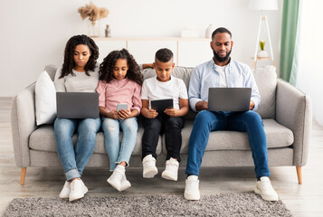 Wall Mural - African american family holding and using gadgets