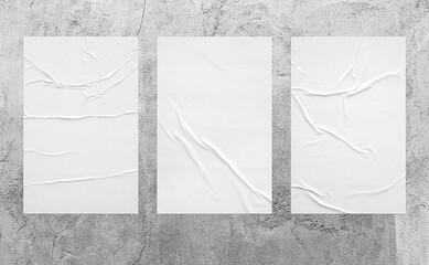 three vertical glued paper on the aged grey wall.  wrinkled texture surface can be used for mockup poster, campaign, promotion in street theme. realistic shabby 3d texture illustration.