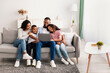 © Prostock-studio - Happy african american family using laptop in living room