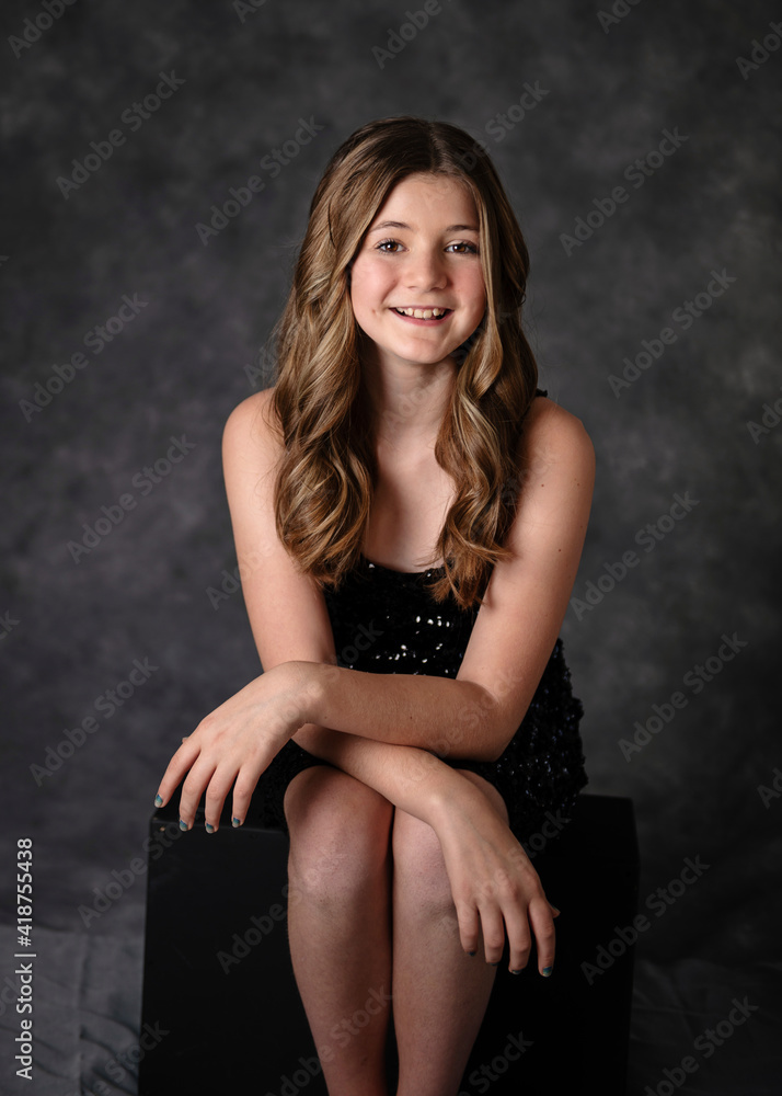 Beautiful confident tween girl with long hair in a black sparkly dress Stock Photo | Adobe Stock Beautiful confident tween girl with long hair in a black sparkly dress Stock Photo | Adobe Stock