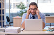 © Elnur - Young male accountant working in the office